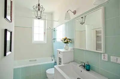 a bathroom with a sink and a toilet and a mirror at Guest House Villa Monet in Prague