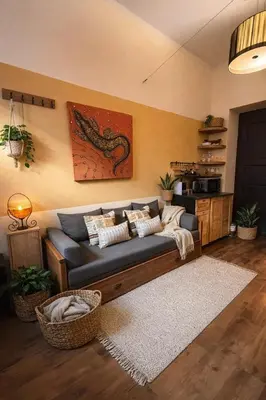 a living room with a couch with a dragon painting on the wall at Cozy Private Studio for Couples & Solo Travelers in Prague