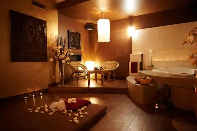 a bathroom with a tub and a table with flowers on the floor at Cozy Private Studio for Couples & Solo Travelers in Prague