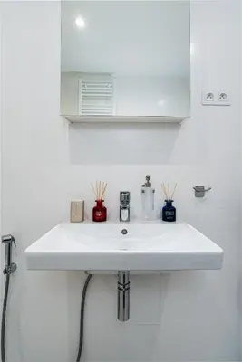 a white sink in a white bathroom at New Bohemian Apartment in Prague