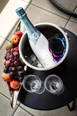 a bottle of wine is in a bucket of fruit at New Bohemian Apartment in Prague