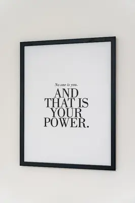 a framed picture of a poster with the text and that is your power at New Bohemian Apartment in Prague