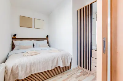 a bedroom with a bed with towels on it at Comfy Apartment with Bedroom Nook in Prague