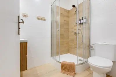 a bathroom with a shower and a toilet at Comfy Apartment with Bedroom Nook in Prague
