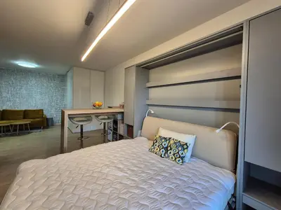 a bedroom with a white bed and a desk at Elegant City Apartment with Balcony near Center in Prague