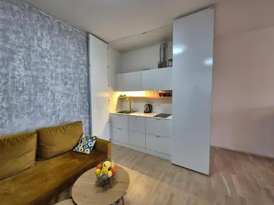 a living room with a couch and a table at Elegant City Apartment with Balcony near Center in Prague