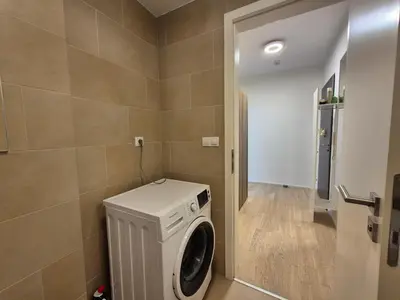 a laundry room with a washer and dryer at Elegant City Apartment with Balcony near Center in Prague