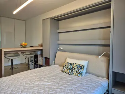 a bedroom with a bed and a desk at Elegant City Apartment with Balcony near Center in Prague