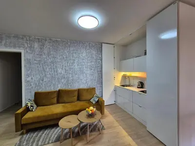 a living room with a couch and a table at Elegant City Apartment with Balcony near Center in Prague