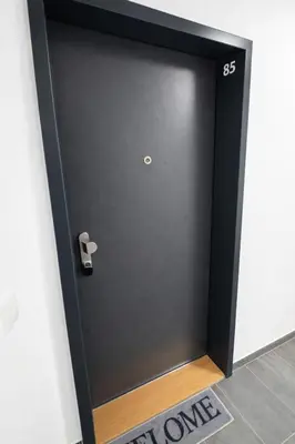 a black door with a number on it at Stylish Studio with Private Hot Tub & Terrace in Prague