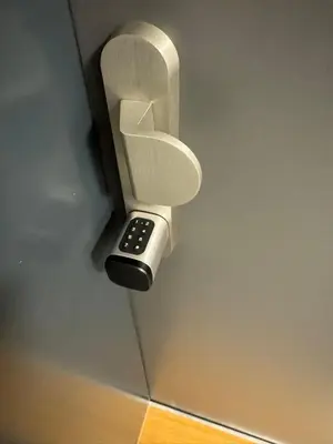 a remote control sticking out of a phone holder at Stylish Studio with Private Hot Tub & Terrace in Prague