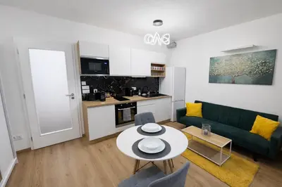 a living room with a green couch and a table at Stylish Studio with Private Hot Tub & Terrace in Prague