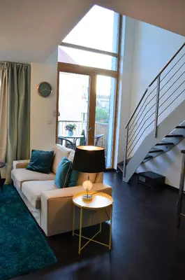 a living room with a couch and a table at Apartments Palmovka in Prague