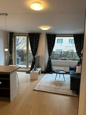 a living room with a couch and a table at Apartments Palmovka in Prague