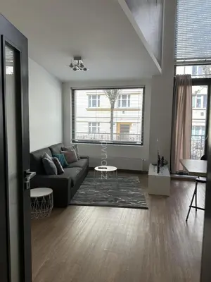 a living room with a couch and a table at Apartments Palmovka in Prague