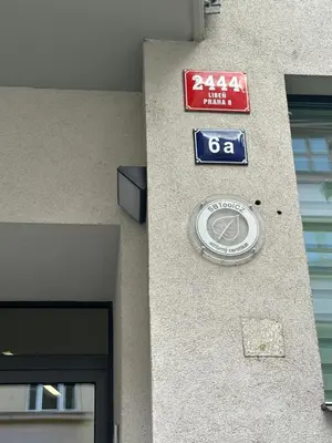 a building with a sign on the side of it at Apartments Palmovka in Prague