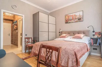 a bedroom with a large bed with pink pillows at Elegant Prague Center Studio - Historic Building in Prague