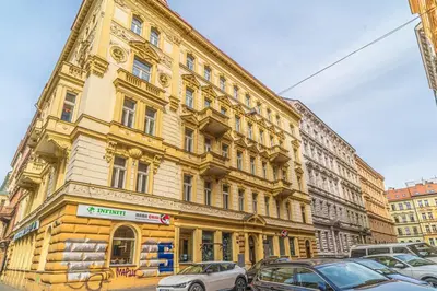 a large building with cars parked in front of it at Elegant Prague Center Studio - Historic Building in Prague