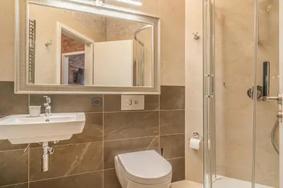 a bathroom with a sink and a toilet and a mirror at Elegant Prague Center Studio - Historic Building in Prague