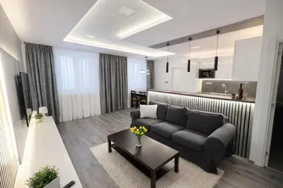 a living room with a couch and a table at Luxury 2BR Apartment Best Location Prague in Prague