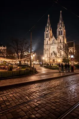 a cathedral at night with people walking in front of it at Luxury 2BR Apartment Best Location Prague in Prague
