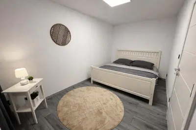 a small bedroom with a bed and a table at Luxury 2BR Apartment Best Location Prague in Prague
