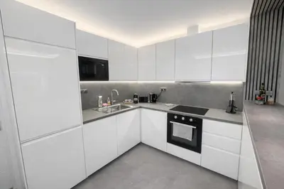 a white kitchen with white cabinets and a sink at Luxury 2BR Apartment Best Location Prague in Prague