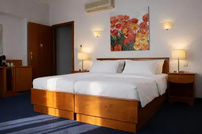 a hotel room with a bed and a couch at Pawlovnia Hotel in Prague