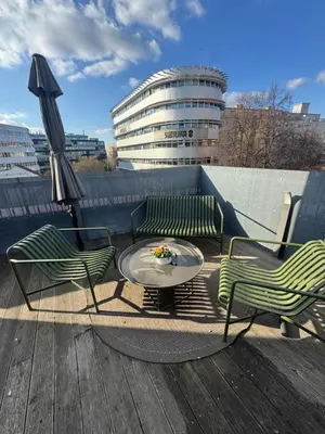a patio with two chairs and a table and an umbrella at The Urban Nest - Grand Residence in Prague