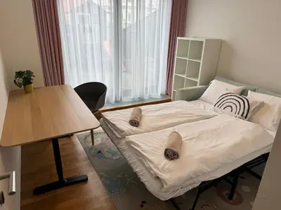 a small room with a bed and a table at The Urban Nest - Grand Residence in Prague