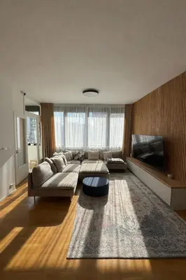 a living room with a couch and a tv at The Urban Nest - Grand Residence in Prague