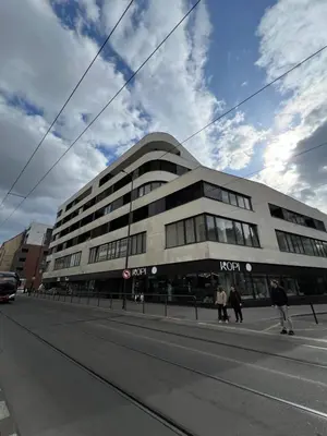 a building on a street with people walking in front of it at The Urban Nest - Grand Residence in Prague