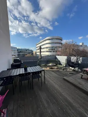 a patio with a table and chairs on a roof at The Urban Nest - Grand Residence in Prague