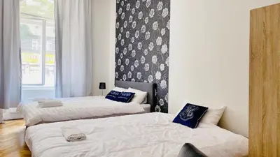 a bedroom with two beds and a wall at LOvely room in the Centre in Prague