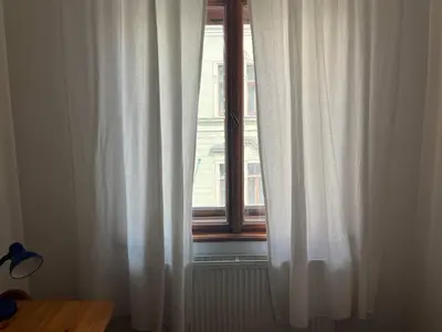 a window with white curtains in a room at Central cozy rooms Soukenická S35 in Prague