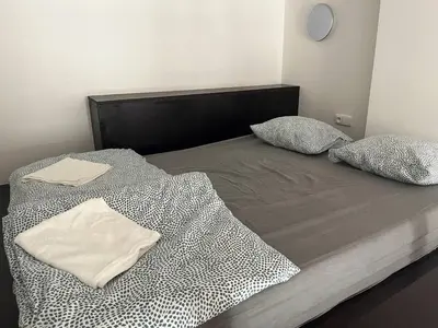 a bed with a black and white comforter and pillows at Central cozy rooms Soukenická S35 in Prague