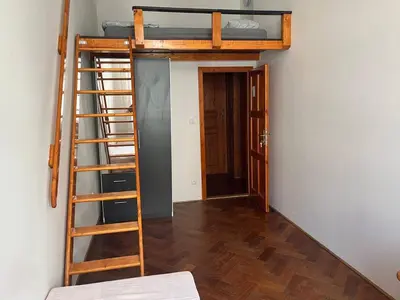 a room with two bunk beds and a ladder at Central cozy rooms Soukenická S35 in Prague