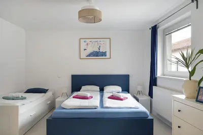 a bedroom with a bed with two pillows on it at Tichý byt blízko Pražského hradu in Prague
