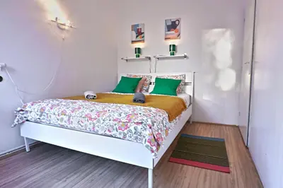 a bedroom with a bed with green pillows at Prague Family Guest House - Rooms with shared bathroom in Prague