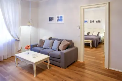 a living room with a couch and a table at White & Gray Apartments in Prague