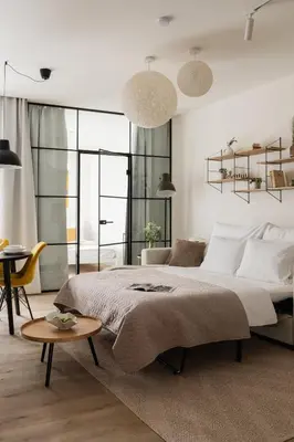 a bedroom with a large bed and a table at U Zvonu Deluxe Apartments with Self Check-in in Prague