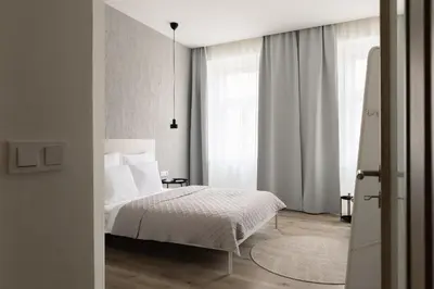 a bedroom with a bed with white sheets and white pillows at U Zvonu Deluxe Apartments with Self Check-in in Prague