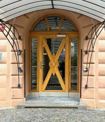 a wooden door with a wooden cross on it at Modern New Town Studio Heart of the City in Prague