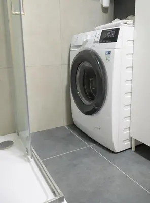 a washer and dryer in a laundry room at Modern New Town Studio Heart of the City in Prague