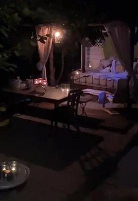 a table with candles on a patio at night at Chatička Anička or Garden 77 in Prague