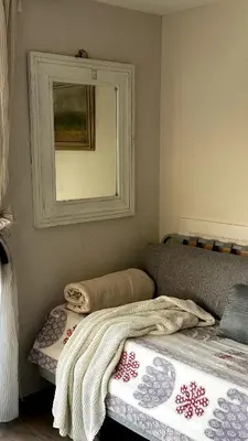 a room with two beds and a mirror on the wall at Chatička Anička or Garden 77 in Prague