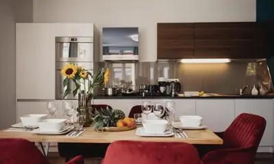 a dining room table with a vase of sunflowers on it at COZY&DELUX Family apartment 3 min from Metro in Prague