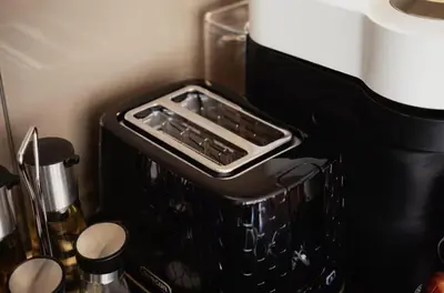 a black kitchen appliance with an emptyasser at COZY&DELUX Family apartment 3 min from Metro in Prague