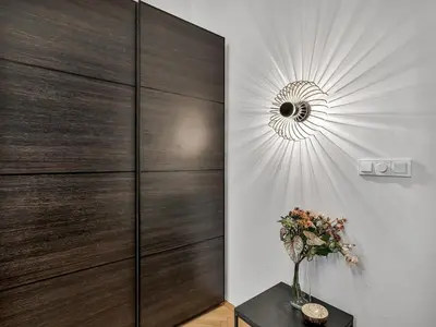 a vase of flowers on a table in a room at Design Spacy Apartman by City Center in Prague