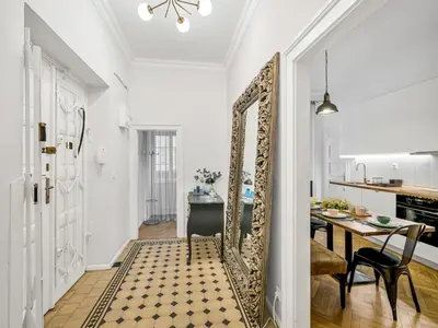 a hallway with a mirror and a dining room at Design Spacy Apartman by City Center in Prague